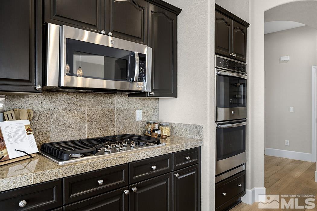 2200 South Tesuque Road Reno, NV 89511 - Photo 6 of 28 a kitchen with stainless steel appliances a stove and a microwave