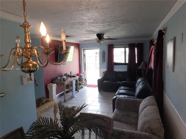 a living room with furniture and a chandelier