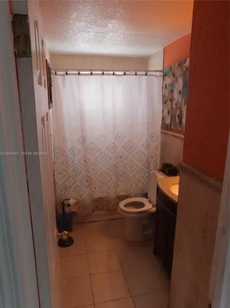 a bathroom with a toilet and shower