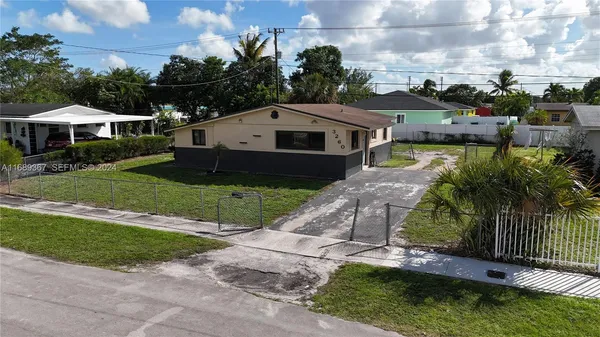 a aerial view of a house next to a yard