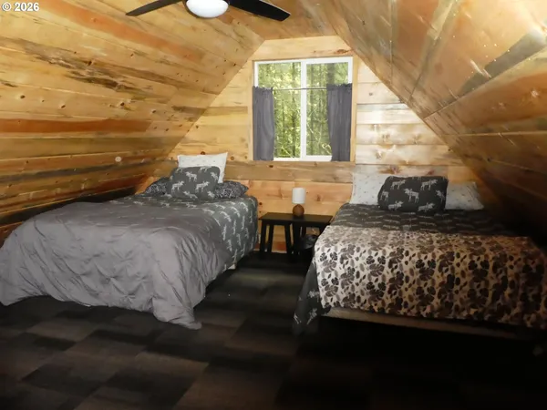 a bedroom with a bed next to a window