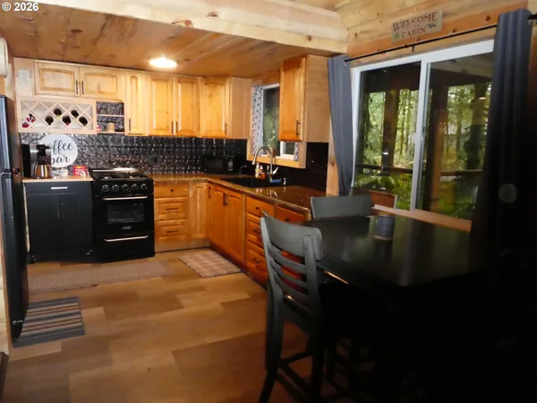 a kitchen with stainless steel appliances granite countertop a sink a stove and a refrigerator
