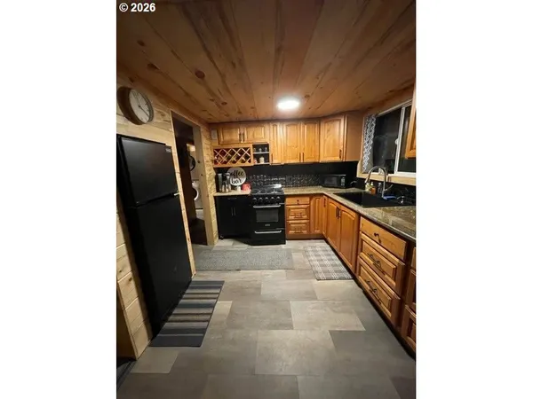 a kitchen with stainless steel appliances granite countertop a refrigerator and a stove