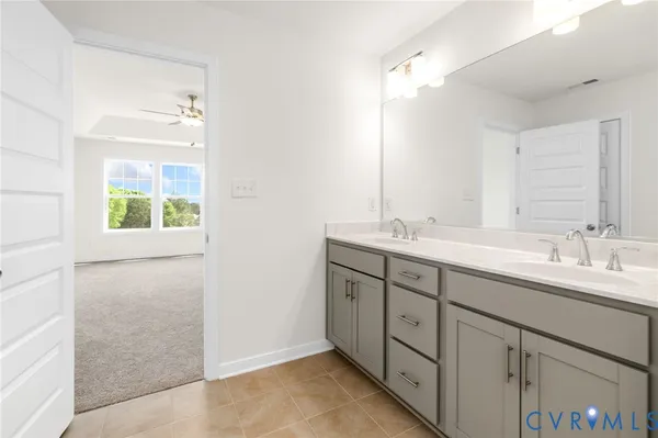 a bathroom with a double vanity sink and a mirror