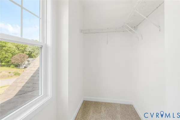 a view of a small space with wooden floor and a window