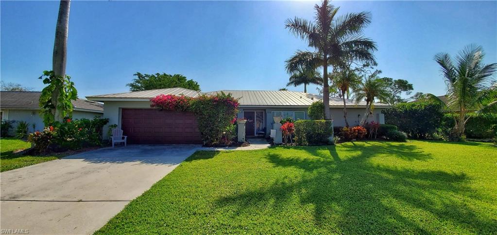 391 Torrey Pines Point Naples, FL 34113 - Photo 1 of 32 a front view of a house with garden