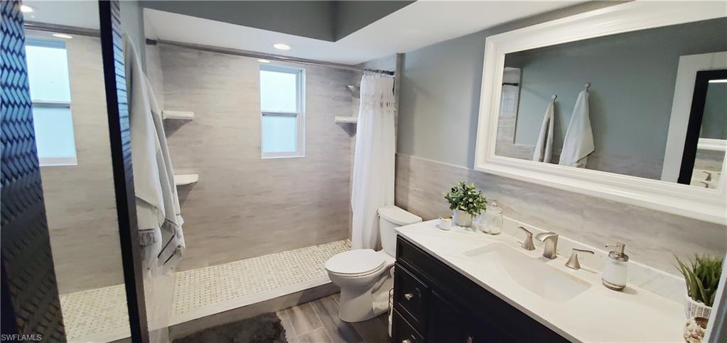391 Torrey Pines Point Naples, FL 34113 - Photo 15 of 32 a bathroom with a sink a toilet and shower