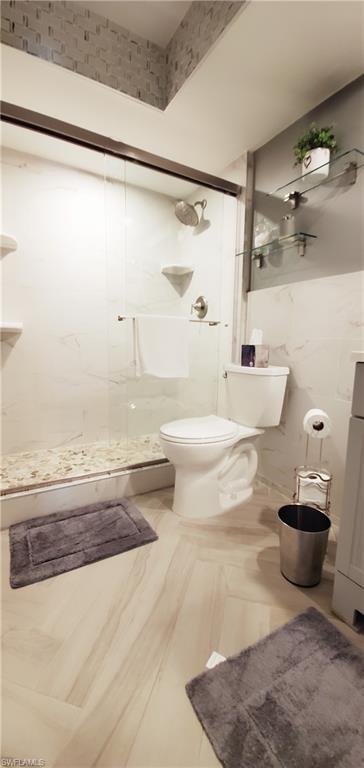 391 Torrey Pines Point Naples, FL 34113 - Photo 23 of 32 a bathroom with a bathtub and a shower