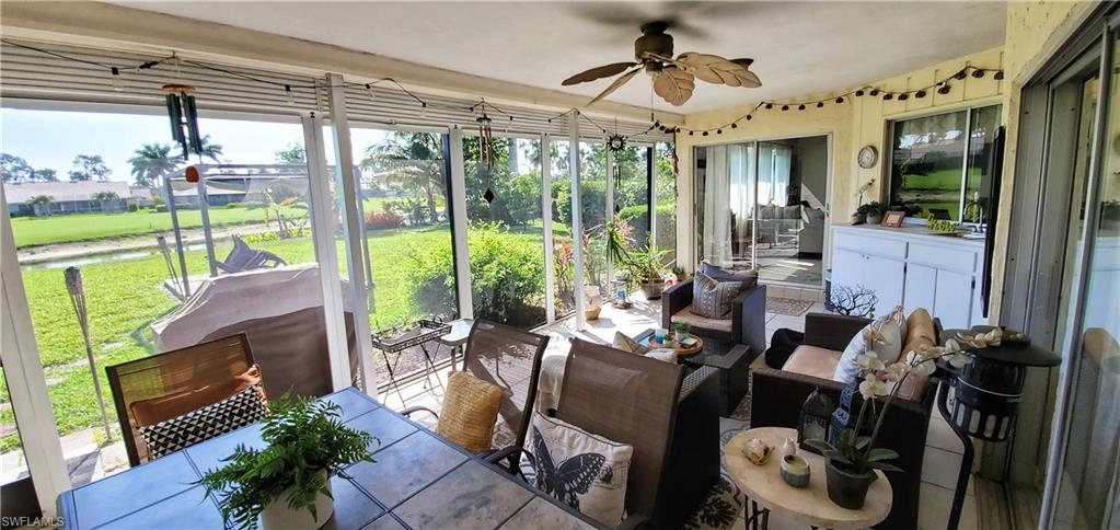 391 Torrey Pines Point Naples, FL 34113 - Photo 27 of 32 a living room with patio furniture and a floor to ceiling window
