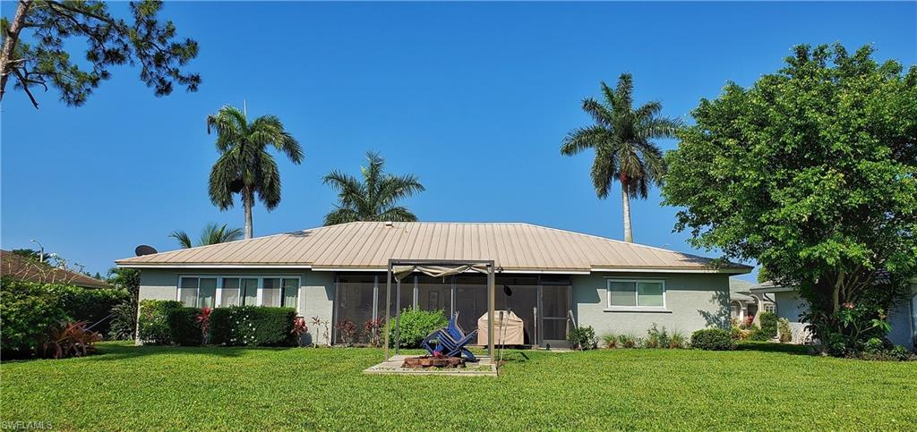 391 Torrey Pines Point Naples, FL 34113 - Photo 30 of 32 a front view of a house with garden