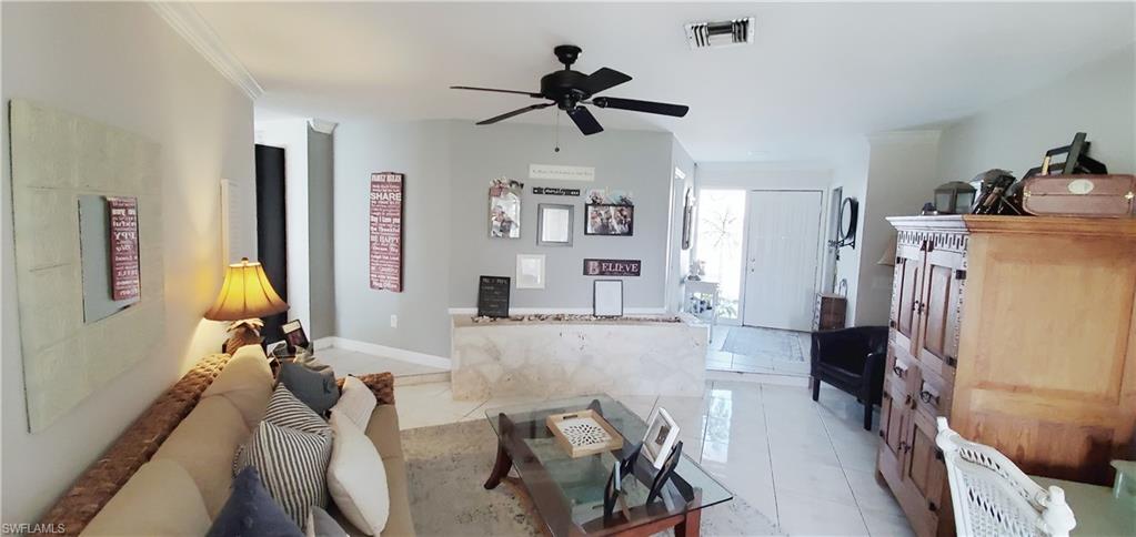 391 Torrey Pines Point Naples, FL 34113 - Photo 6 of 32 a view of a livingroom with furniture and a ceiling fan