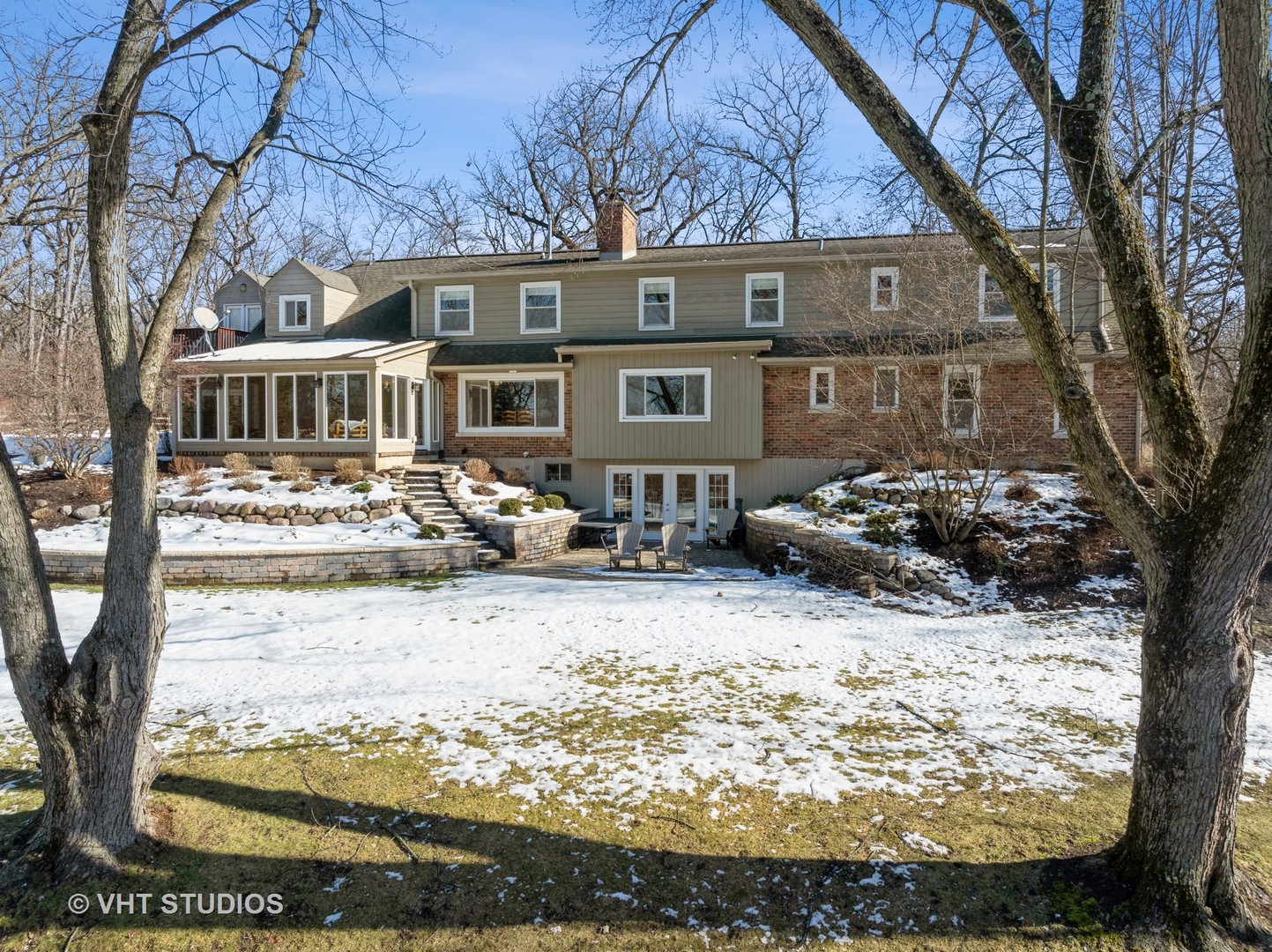 a front view of a house with yard covered in snow