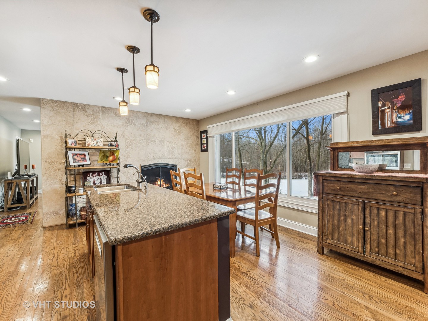 3143 Cuba Road Long Grove, IL 60047 - Photo 11 of 40 a kitchen with stainless steel appliances granite countertop a kitchen island a stove a table and chairs with wooden floor
