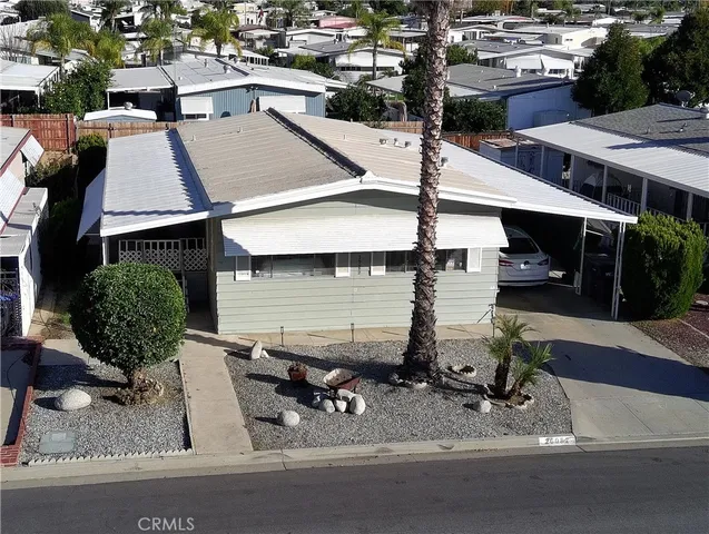 an aerial view of a house with garden space and sitting area