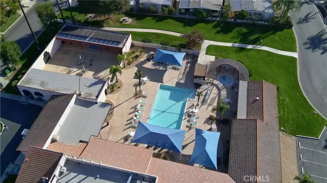 an aerial view of a house with a garden and trees