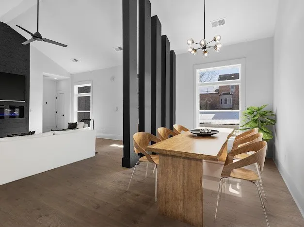 a room with a table chairs and flat screen tv