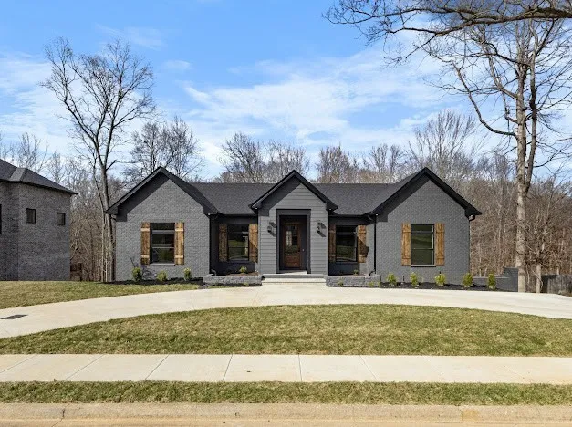 a view of a house with a yard covered in snow