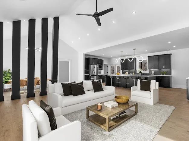 a living room with furniture kitchen view and a wooden floor