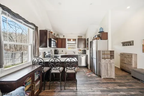 a kitchen with stainless steel appliances granite countertop a stove refrigerator sink and cabinets