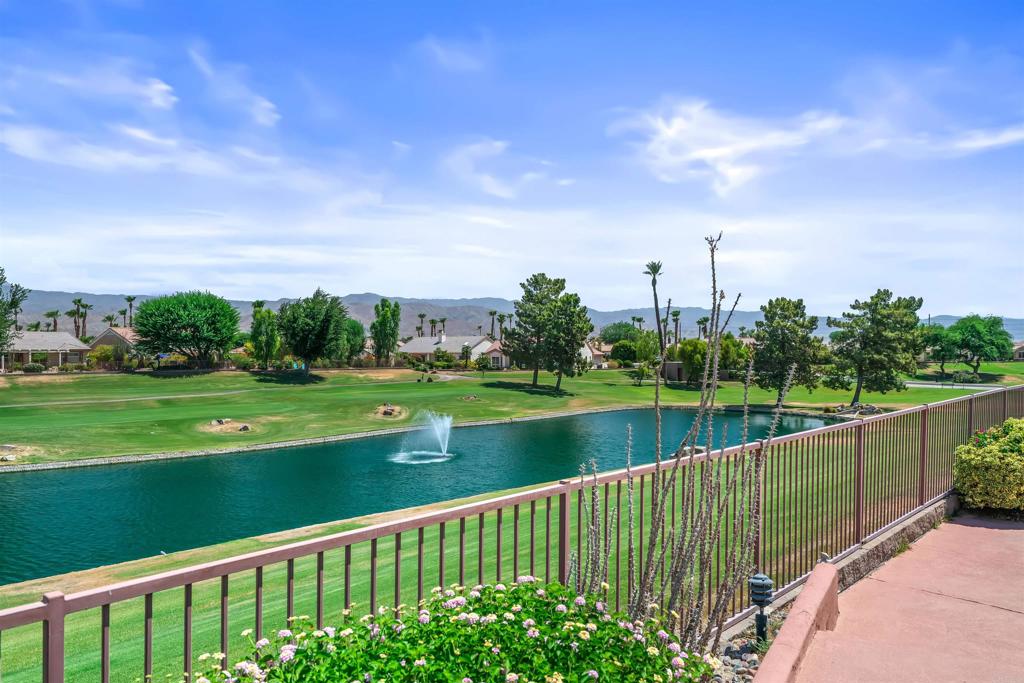 39303 Gleneagles Circle Palm Desert, CA 92211 - Photo 35 of 71 a view of a lake with a garden
