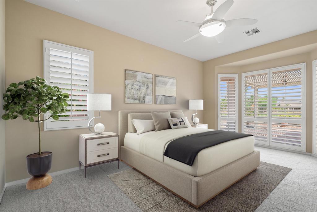 39303 Gleneagles Circle Palm Desert, CA 92211 - Photo 4 of 71 a bedroom with a large bed and a potted plant