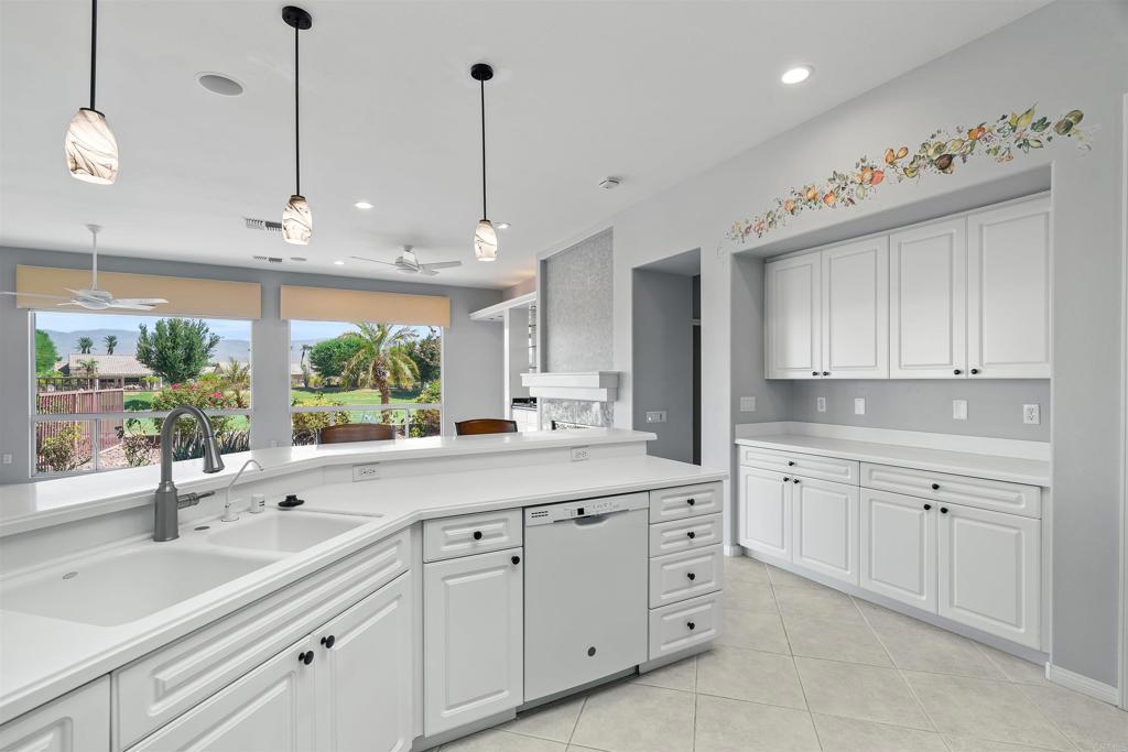 39303 Gleneagles Circle Palm Desert, CA 92211 - Photo 49 of 71 a kitchen with white cabinets and window