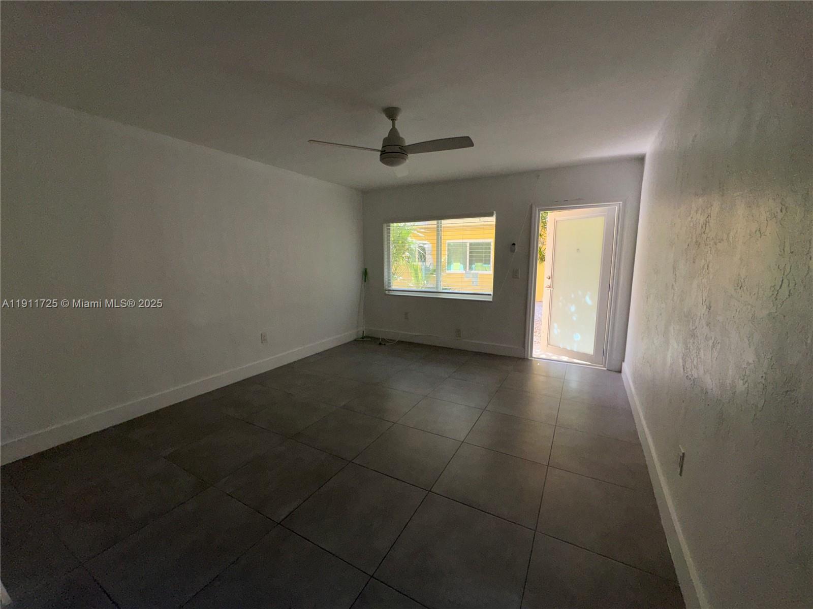 75 Washington Avenue, Unit 10 Miami Beach, FL 33139 - Photo 3 of 6 an empty room with windows and entrance