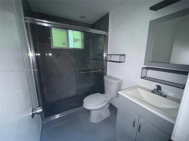 a bathroom with a toilet sink and shower