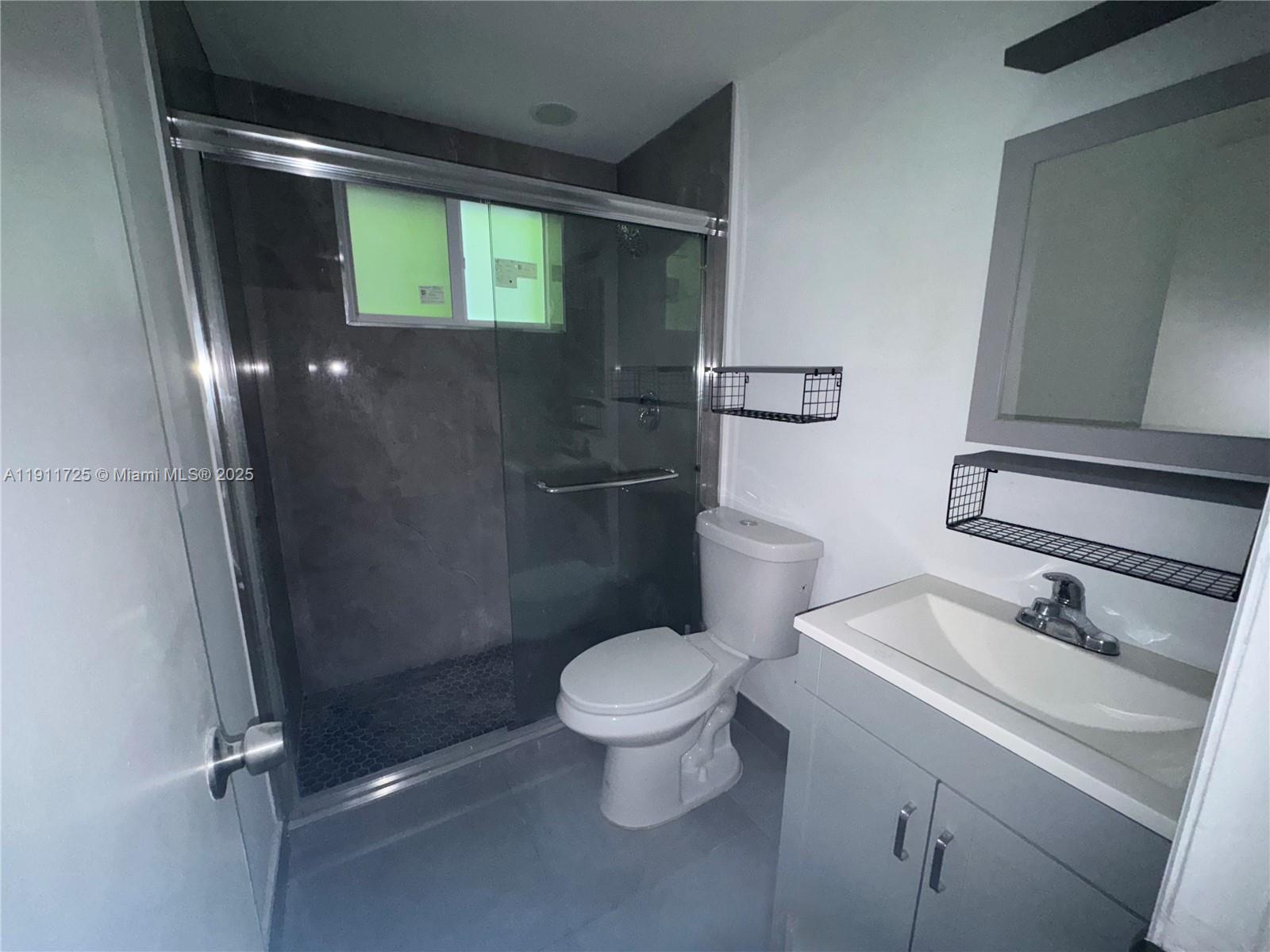 75 Washington Avenue, Unit 10 Miami Beach, FL 33139 - Photo 4 of 6 a bathroom with a toilet sink and shower