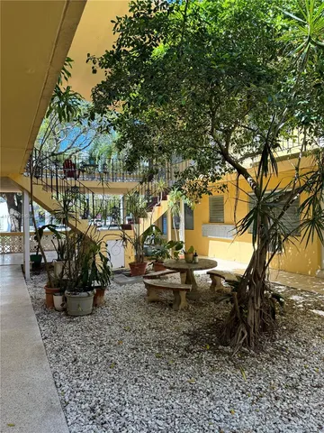 a view of a chairs and table in the backyard