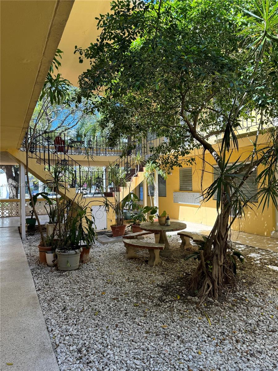 75 Washington Avenue, Unit 10 Miami Beach, FL 33139 - Photo 6 of 6 a view of a chairs and table in the backyard