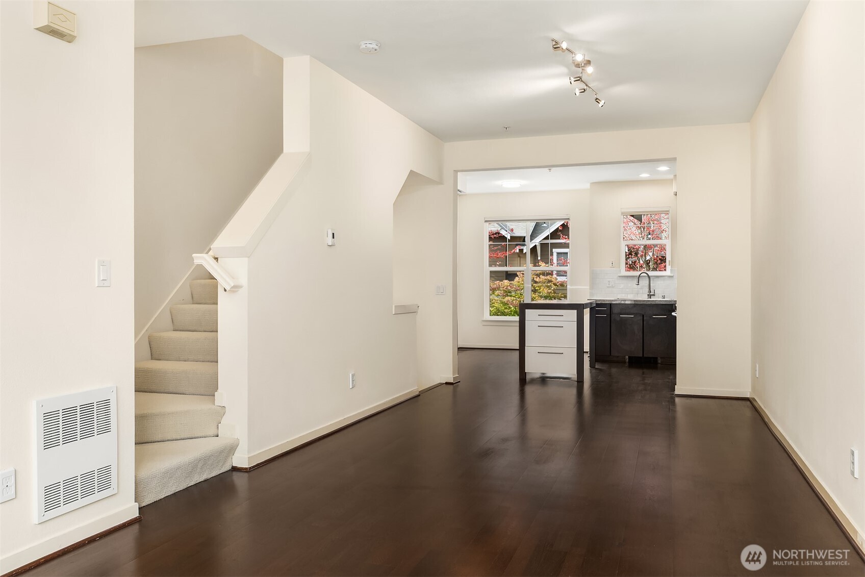 1900 17th Avenue Northeast Issaquah, WA 98029 - Photo 2 of 22 a view of a hallway with wooden floor and kitchen