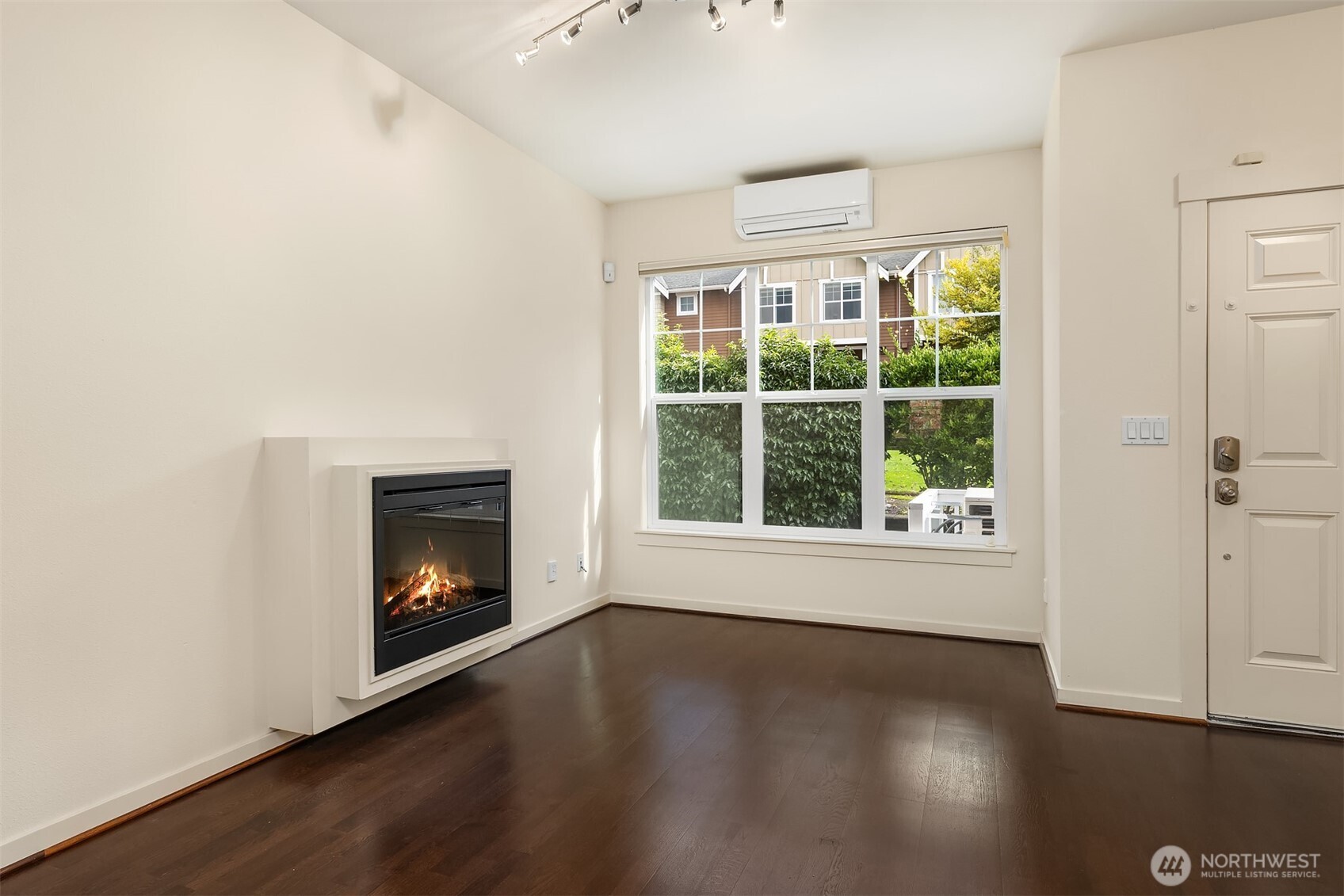 1900 17th Avenue Northeast Issaquah, WA 98029 - Photo 7 of 22 an empty room with wooden floor fire place and windows