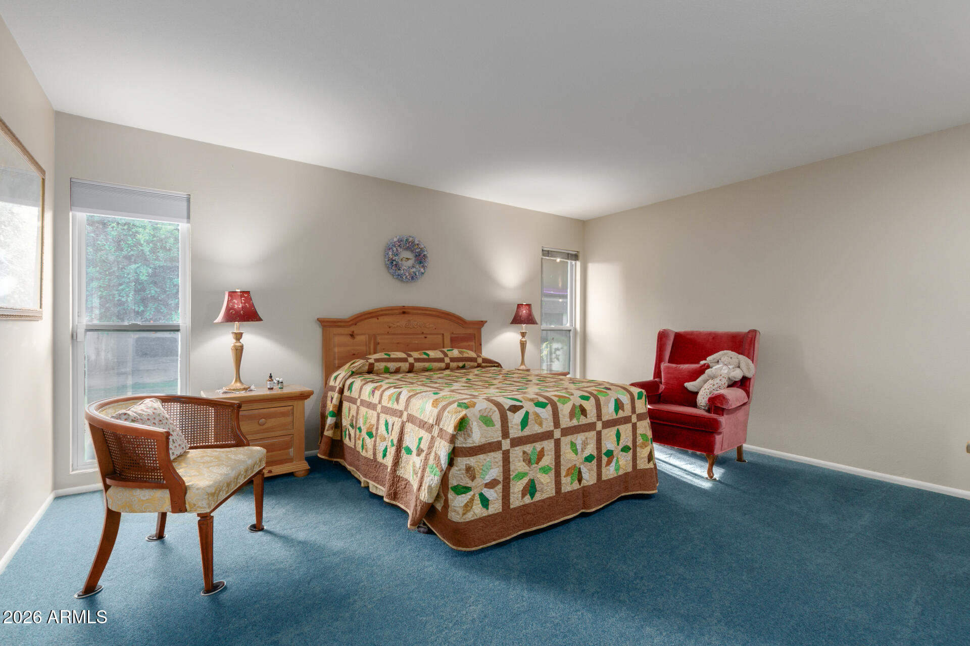 9705 West Oak Ridge Drive Sun City, AZ 85351 - Photo 11 of 23 a bedroom with a bed and a chandelier