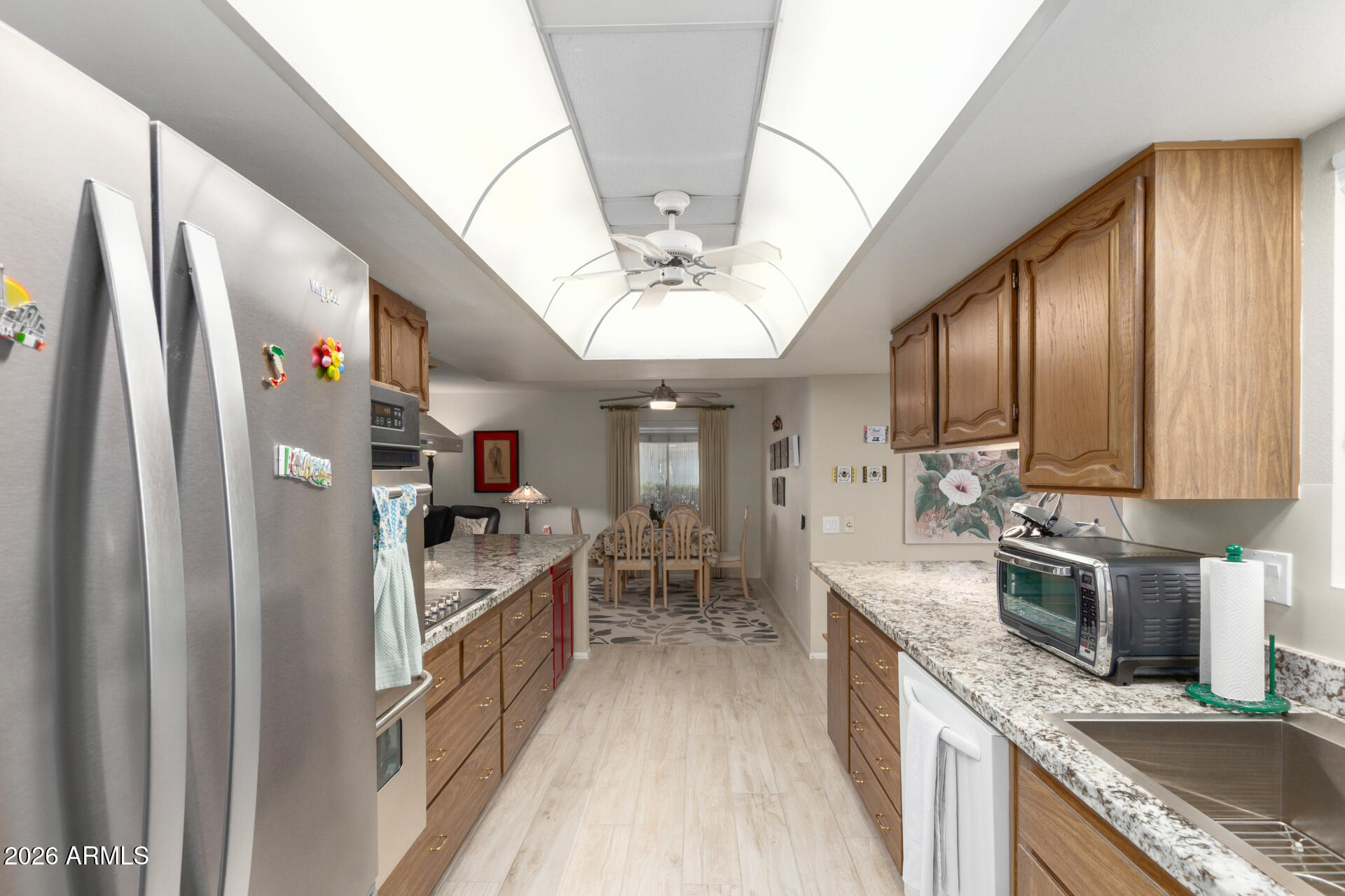 9705 West Oak Ridge Drive Sun City, AZ 85351 - Photo 3 of 23 a kitchen with granite countertop a refrigerator stove and sink