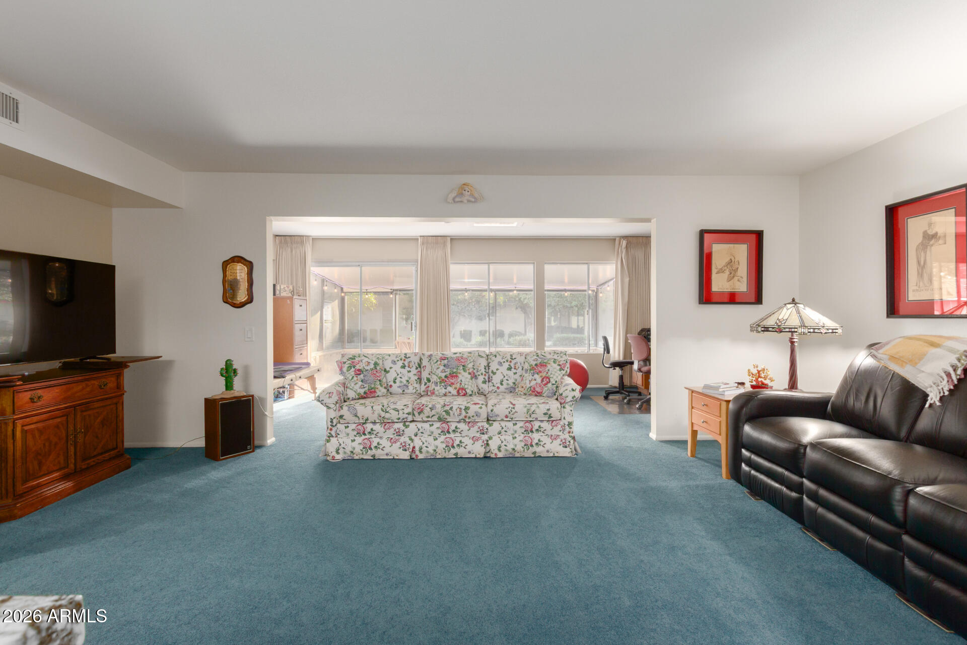 9705 West Oak Ridge Drive Sun City, AZ 85351 - Photo 6 of 23 a living room with furniture and a flat screen tv