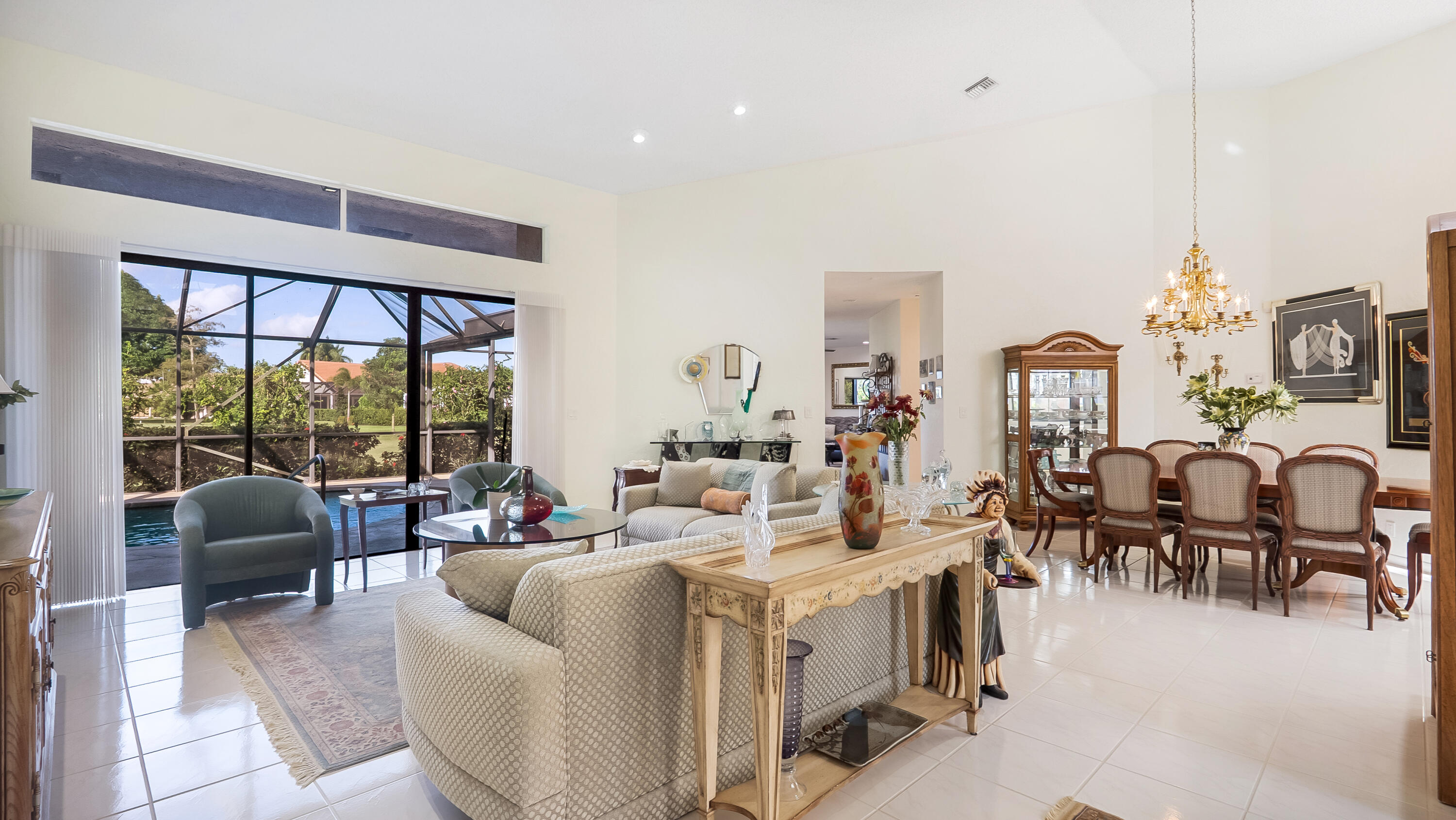 10767 Boca Woods Lane Boca Raton, FL 33428 - Photo 11 of 64 a living room with furniture large window and flat screen tv