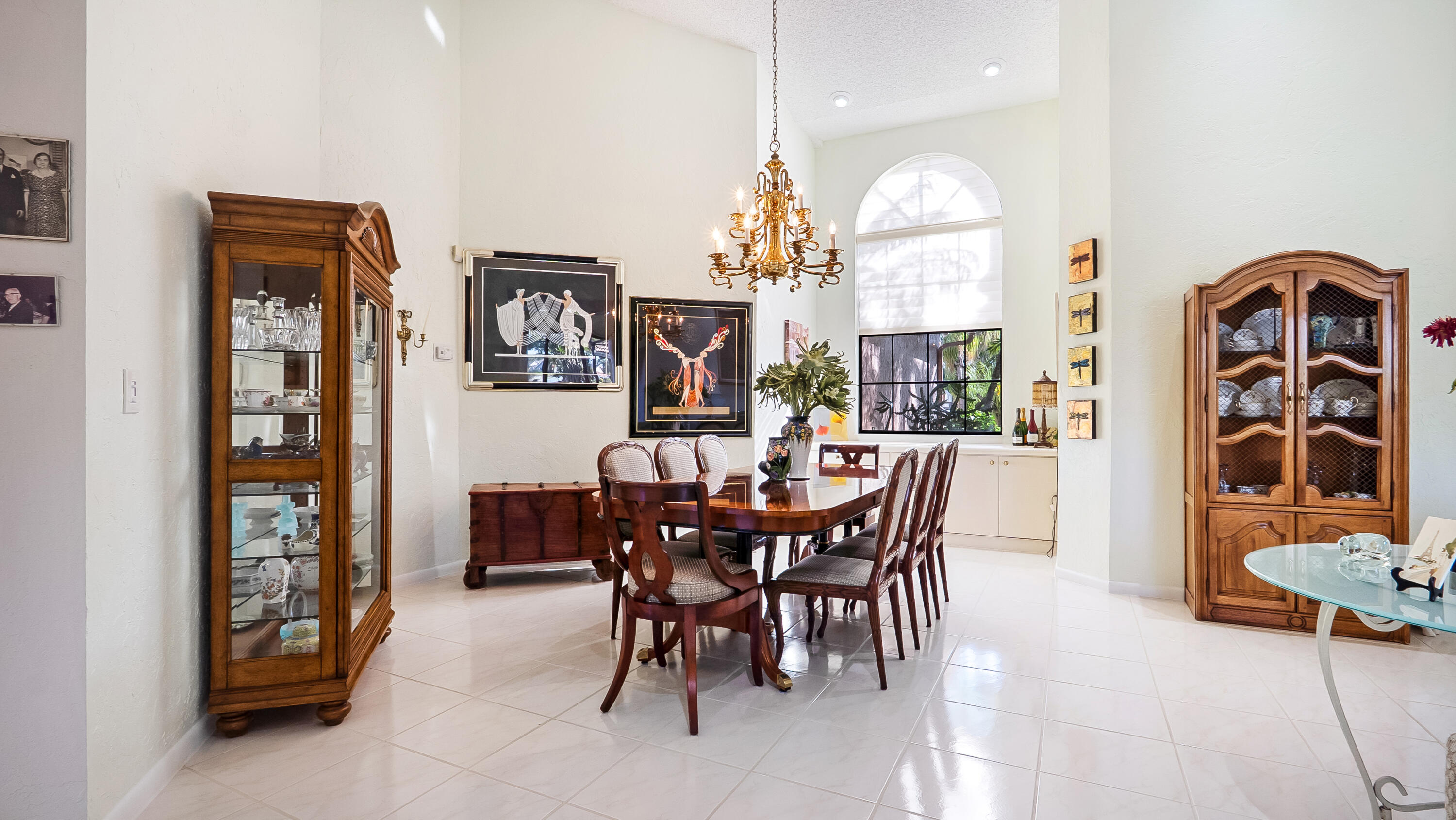 10767 Boca Woods Lane Boca Raton, FL 33428 - Photo 17 of 64 a view of a dining room with furniture and chandelier