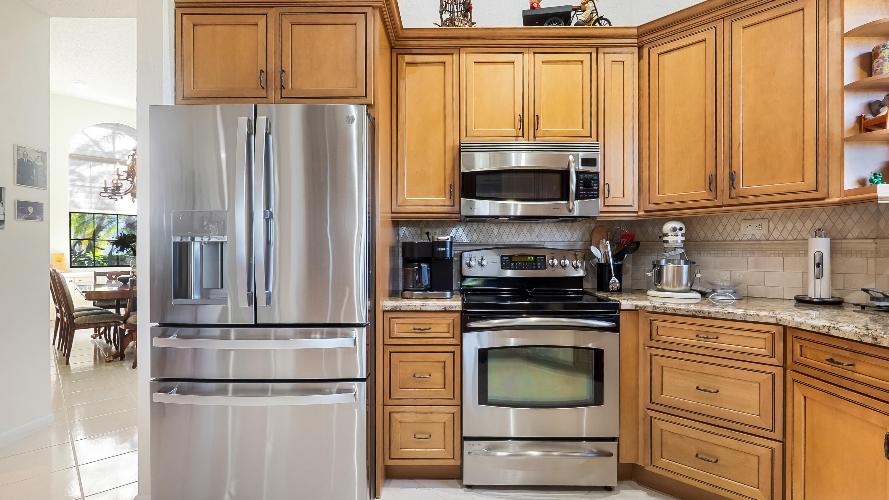 10767 Boca Woods Lane Boca Raton, FL 33428 - Photo 20 of 64 a kitchen with stainless steel appliances granite countertop a refrigerator sink and stove