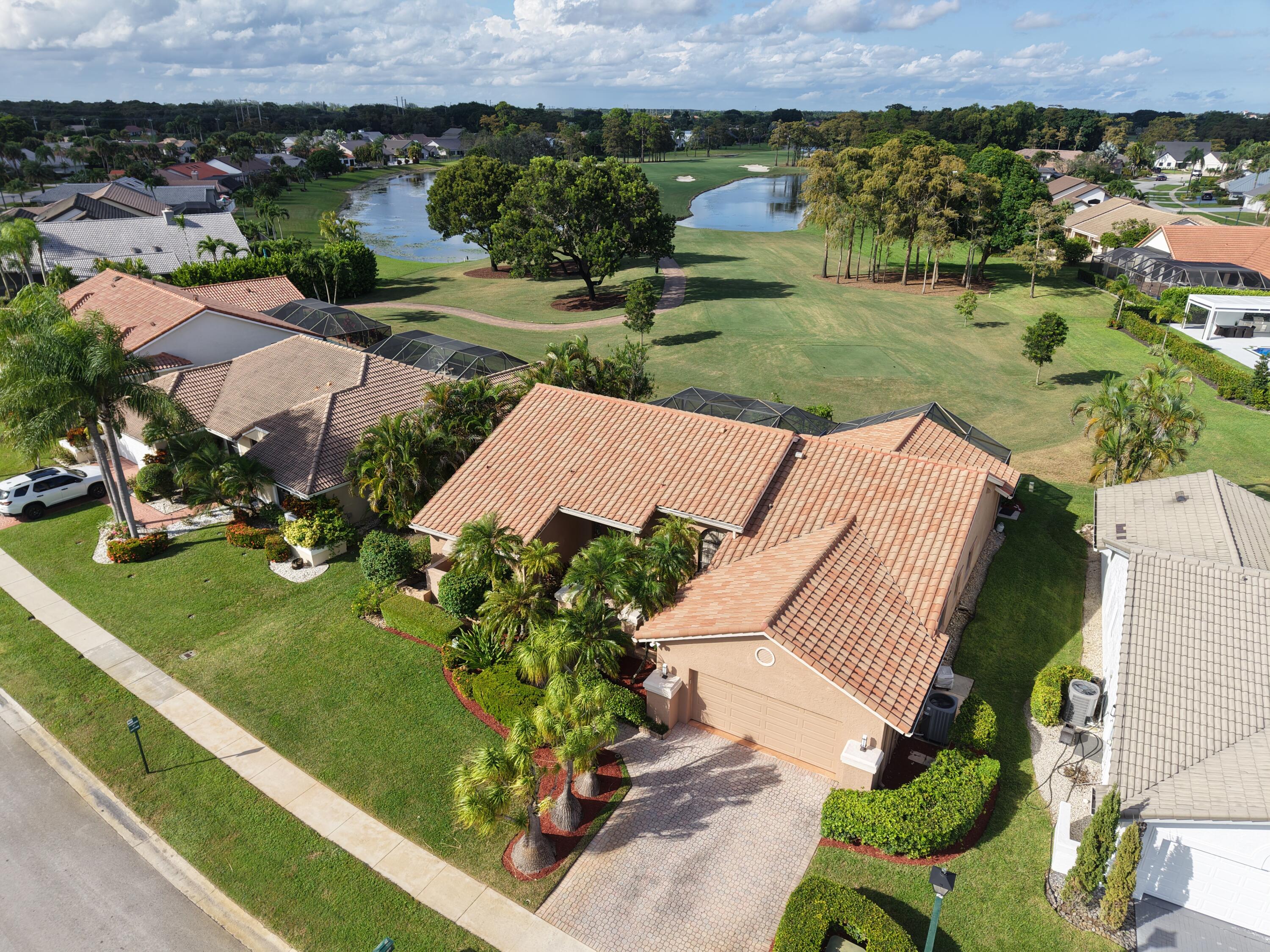 10767 Boca Woods Lane Boca Raton, FL 33428 - Photo 2 of 64 an aerial view of a house with a garden and mountain view