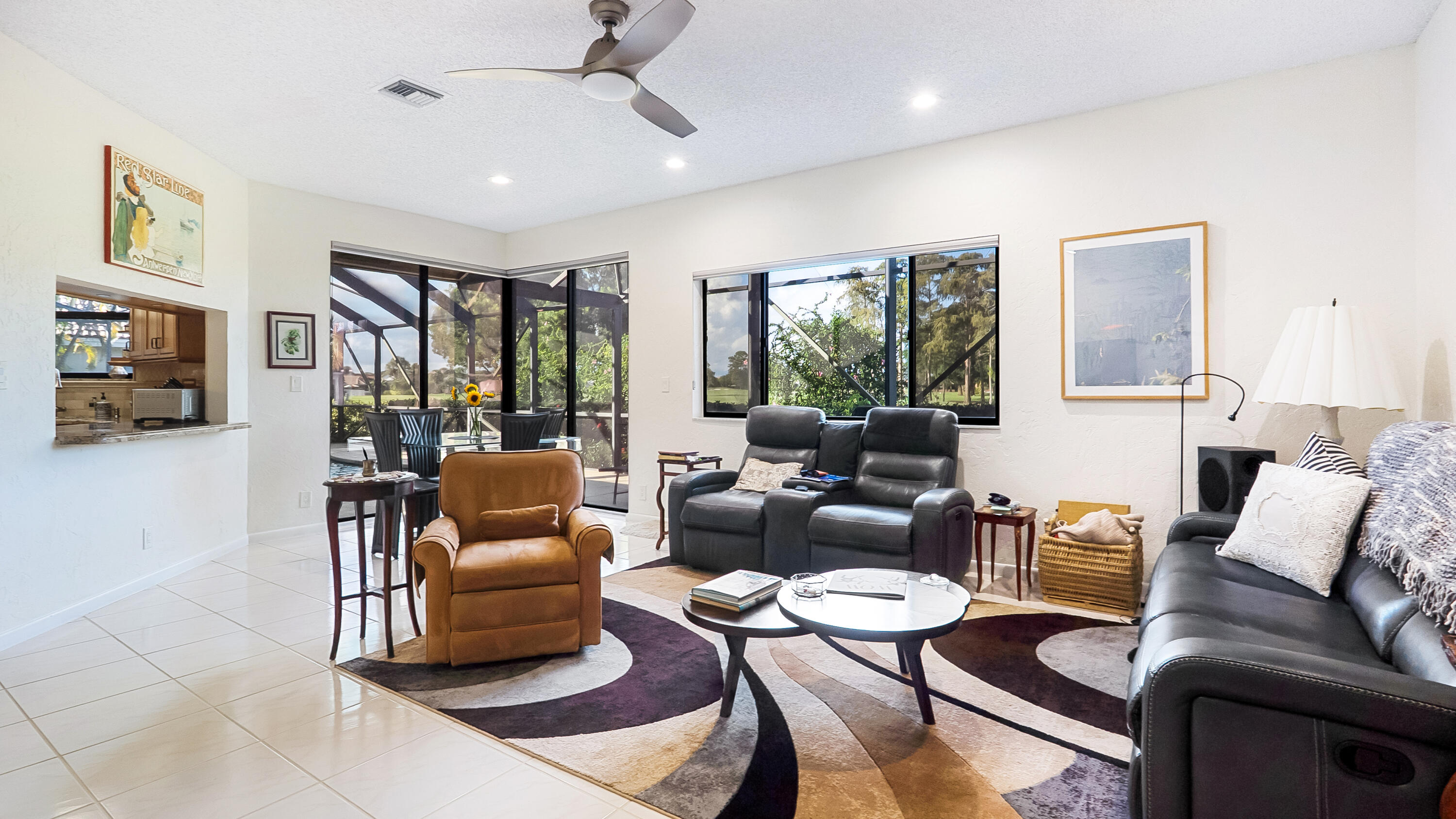 10767 Boca Woods Lane Boca Raton, FL 33428 - Photo 25 of 64 a living room with furniture and a flat screen tv
