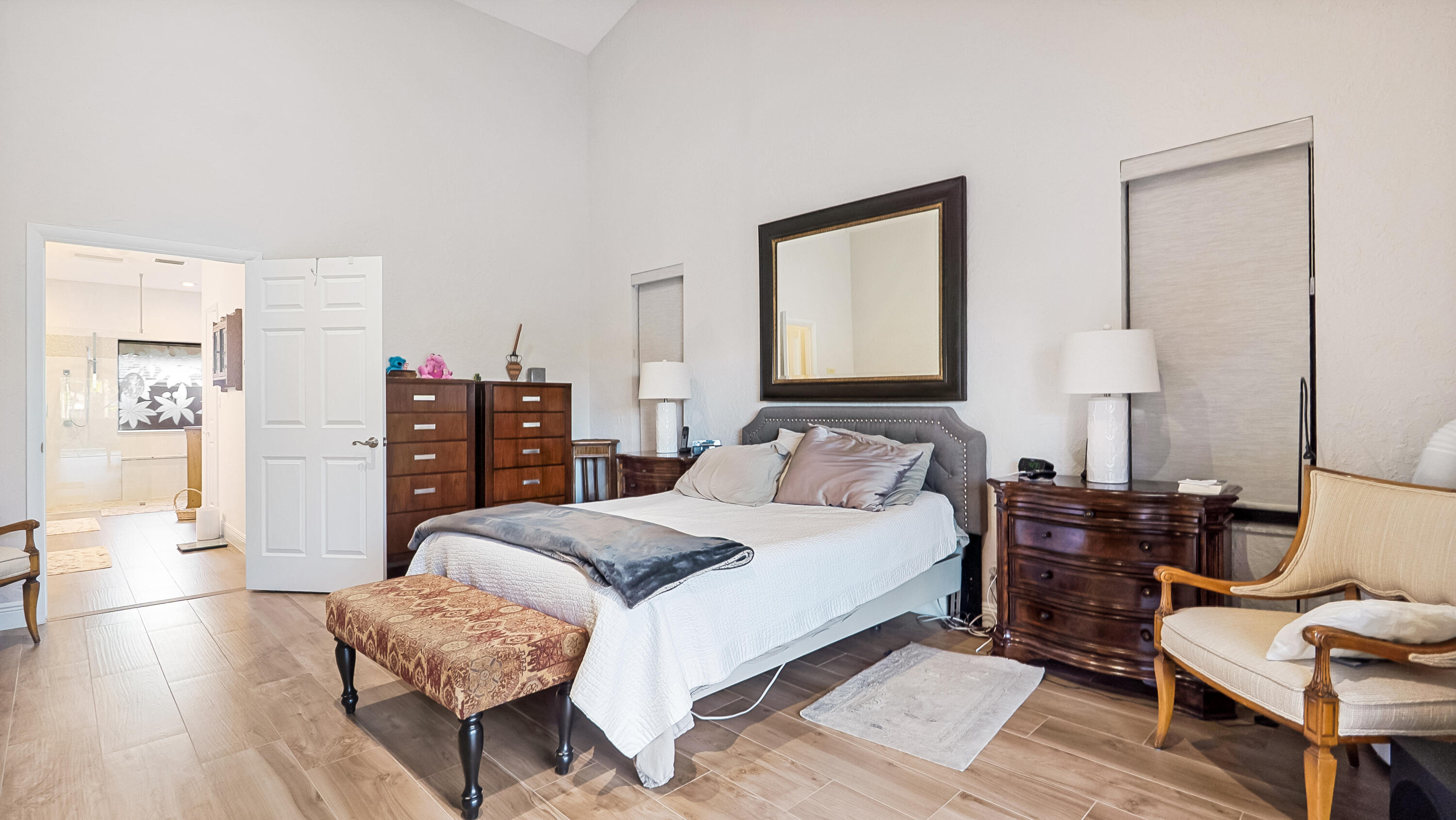 10767 Boca Woods Lane Boca Raton, FL 33428 - Photo 27 of 64 a bedroom with a bed and wooden floor