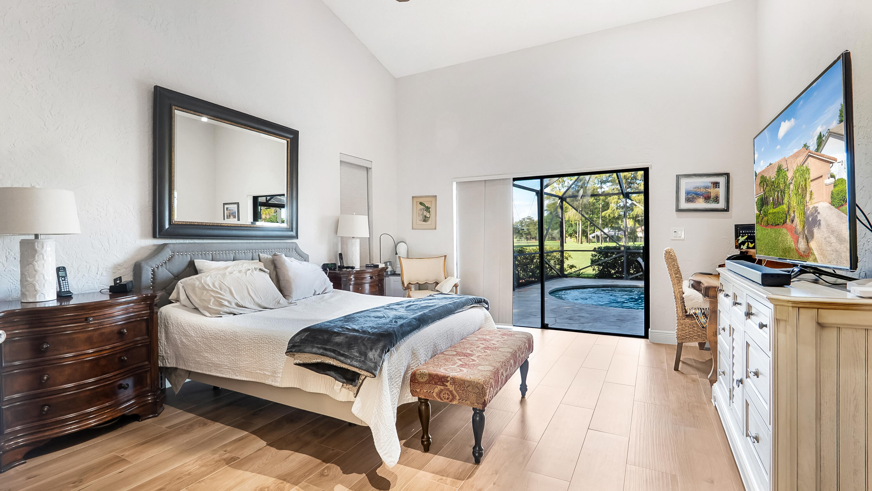 10767 Boca Woods Lane Boca Raton, FL 33428 - Photo 28 of 64 a bedroom with a bed and a flat tv screen on dresser