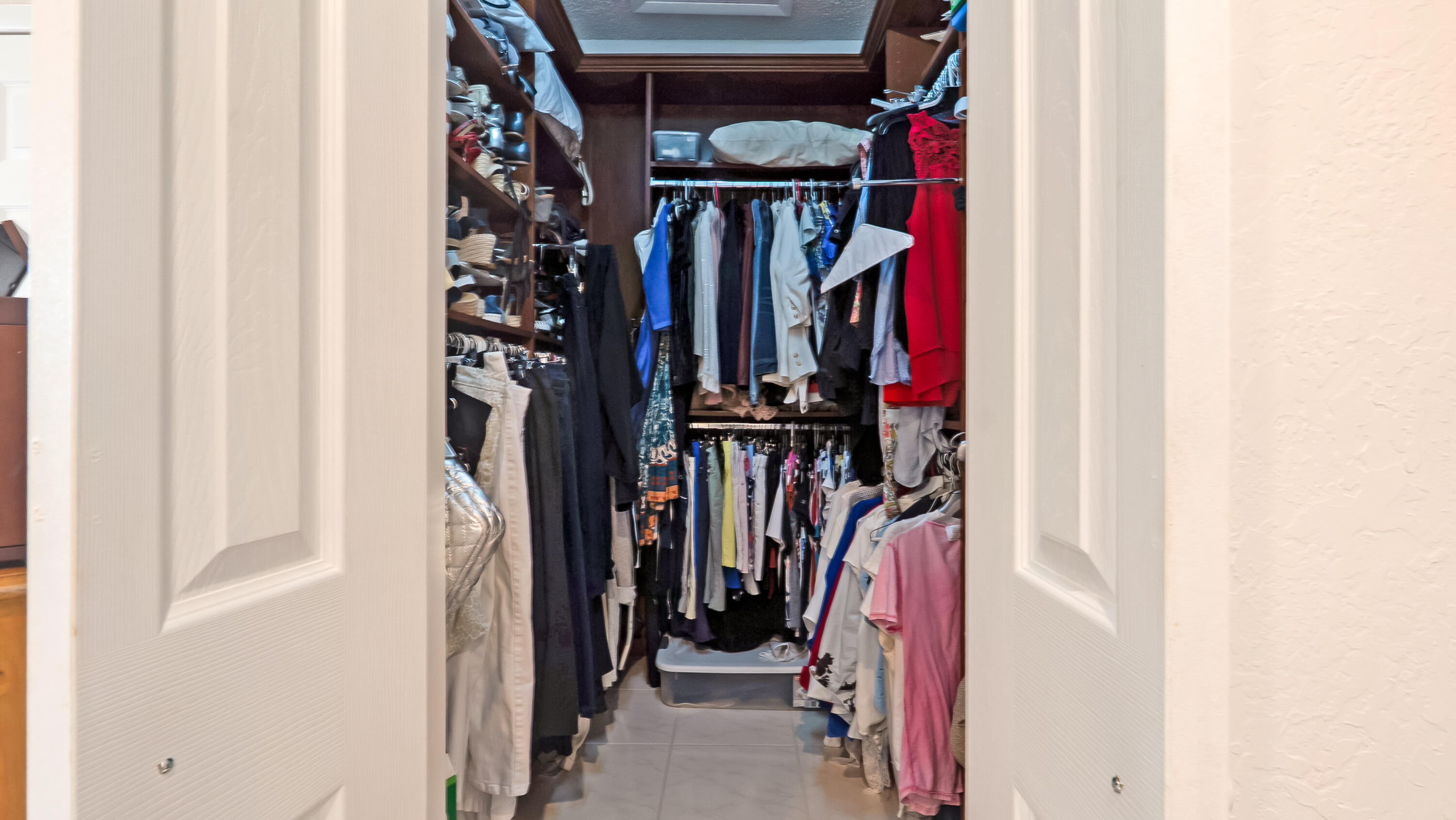 10767 Boca Woods Lane Boca Raton, FL 33428 - Photo 30 of 64 a view of walk in closet with clothes