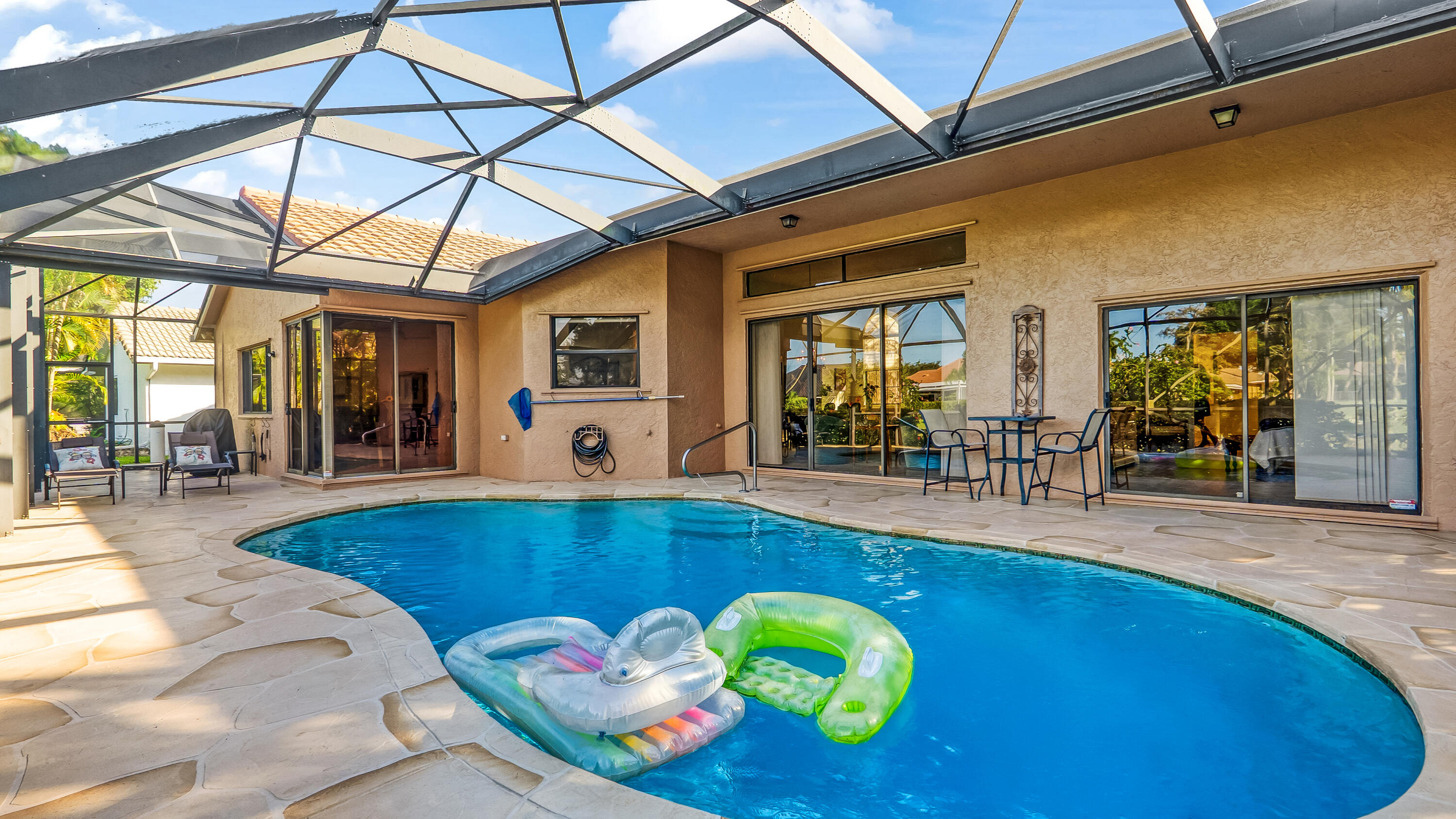 10767 Boca Woods Lane Boca Raton, FL 33428 - Photo 3 of 64 a view of a swimming pool with outdoor seating