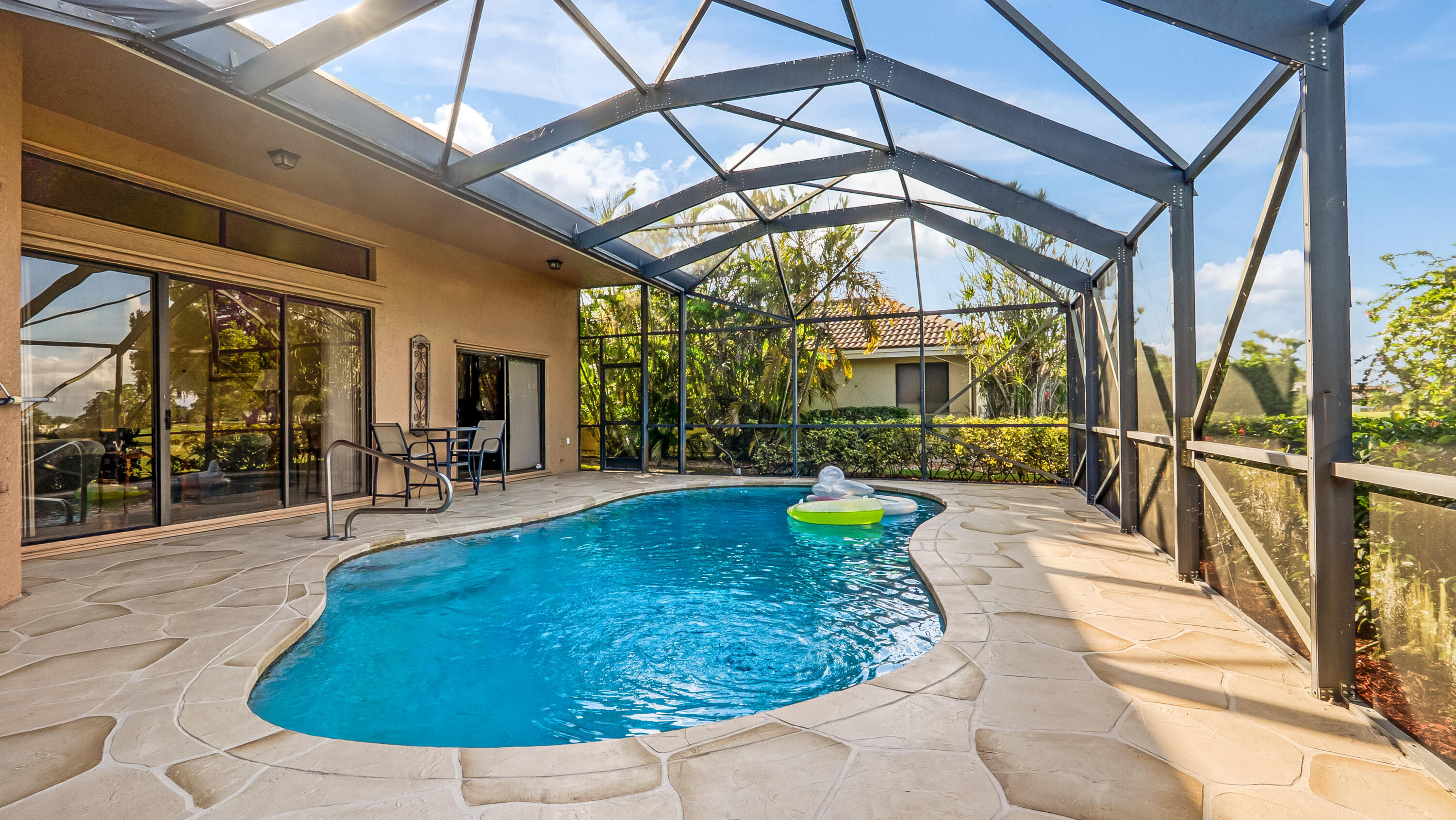 10767 Boca Woods Lane Boca Raton, FL 33428 - Photo 42 of 64 a view of a swimming pool with a patio