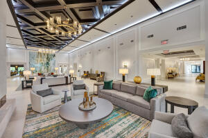 10767 Boca Woods Lane Boca Raton, FL 33428 - Photo 53 of 64 a living room with furniture kitchen view and a chandelier