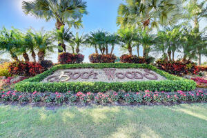 10767 Boca Woods Lane Boca Raton, FL 33428 - Photo 64 of 64 a view of a garden with flowers and palm trees