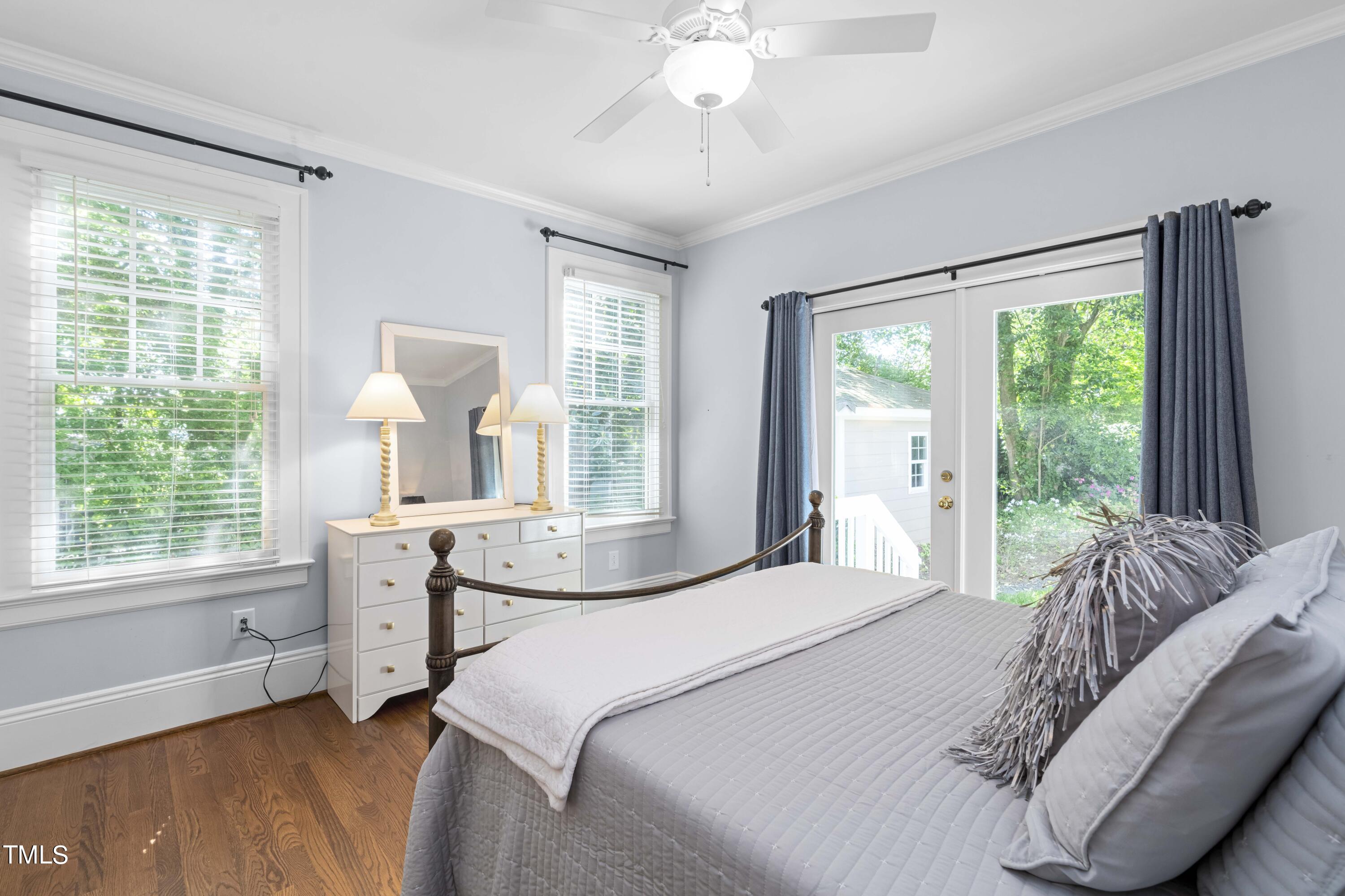 504 Holden Street Raleigh, NC 27604 - Photo 13 of 26 a bedroom with a bed and a large window