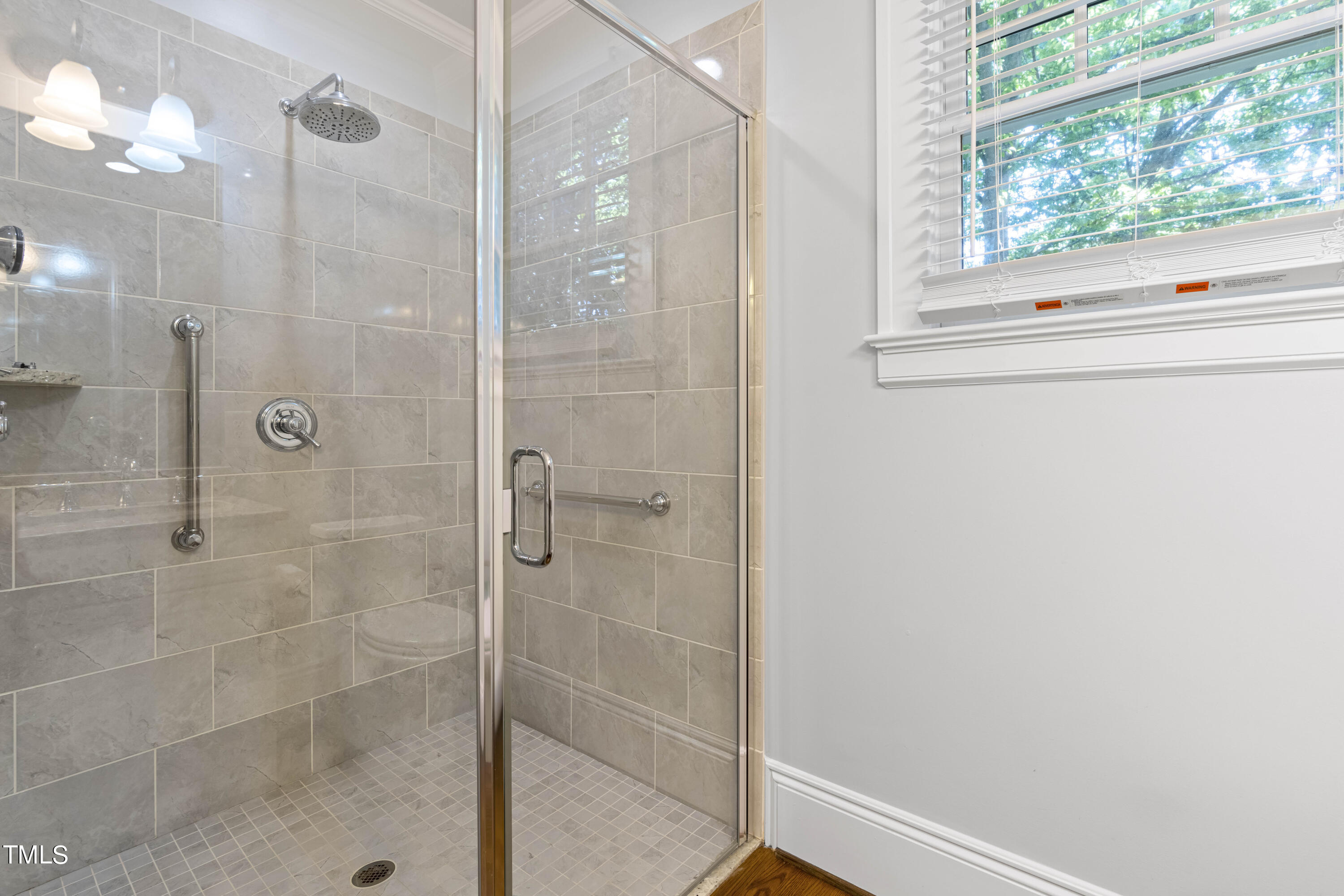 504 Holden Street Raleigh, NC 27604 - Photo 14 of 26 a bathroom with a shower and a window